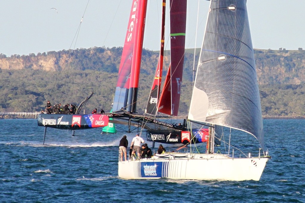 IMG 8385 - Emirates Team NZ turns downwind and is close to paralleling the course of the keelboat sailing goosewinged and running dead downwind. Windward foil is retracted. Windward rudder has lifted clear of the water, but balance is maintained. © Richard Gladwell www.photosport.co.nz