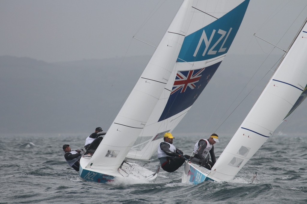 July 31, 2012  Mens Two Handed Keelboat - Hamish Pepper and Jim Turner (NZL) challenging for the lead at the first mark of the Two man Mens Keelboat (Star) class, with Robert Scheidt and Bruna Prada (BRA) to leeward. © Richard Gladwell www.photosport.co.nz