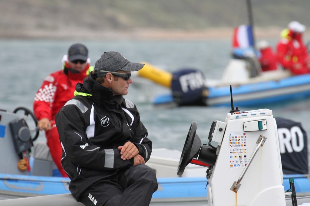  August 3, 2012 - Weymouth, England - New Zealand coach, Nathan Handley follows the progress of his charges, Jo Aleh and Olivia Powrie as they start up the first leg in the first race of the Womens 470 event. They finished second in the race. © Richard Gladwell www.photosport.co.nz