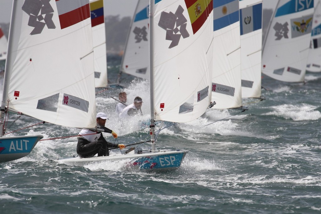  August 4, 2012 - Weymouth, England - The Mens Singlehander (Laser fleet) charge for the gybe mark in Race 9 photo copyright Richard Gladwell www.photosport.co.nz taken at  and featuring the  class