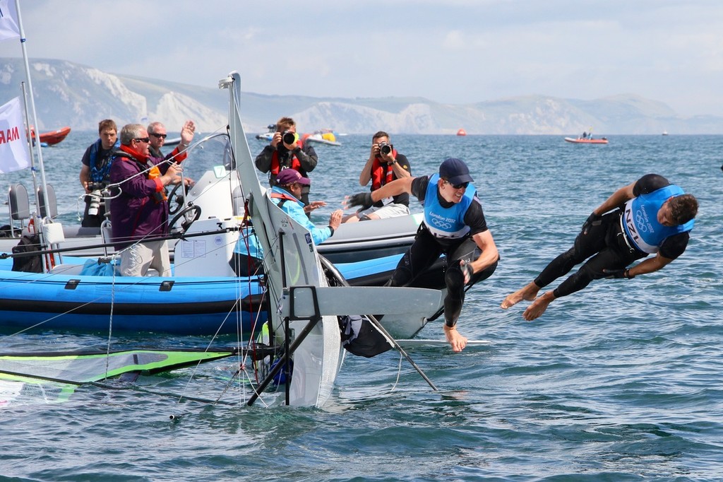  August 8, 2012 - Weymouth, England -Burling and Tuke Take a dip after winning a Silver Medal in the 49er class as the Olympic Competition Manager tries to clear the area for the next event © Richard Gladwell www.photosport.co.nz