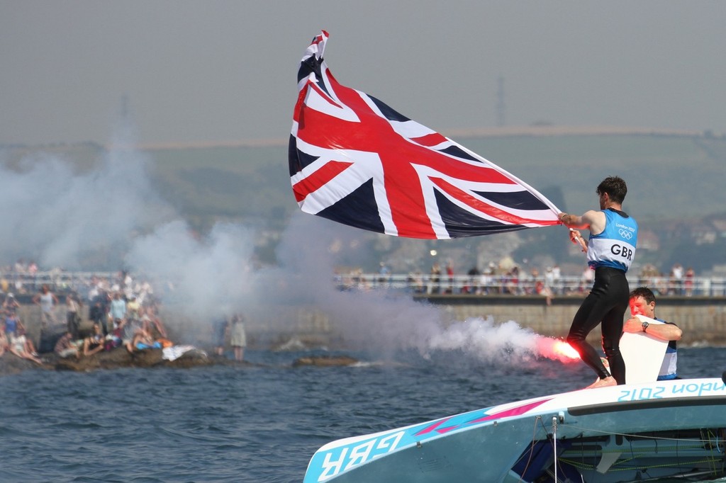 Luke Patience and Stuart Bithell (GBR) set off a flare at the conclusion of the Mens 470 Medal Race © Richard Gladwell www.photosport.co.nz