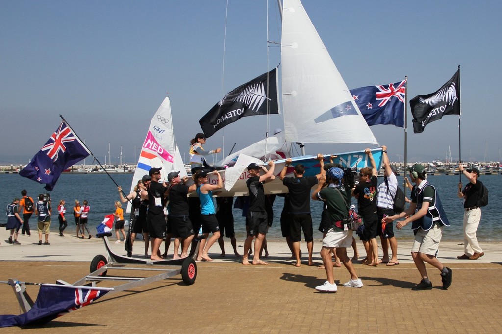  August 10, 2012 - Weymouth, England - Jo Aleh and Olivia Powrie are carried ashor by New Zealand supporters after their Gold Medal win photo copyright Richard Gladwell www.photosport.co.nz taken at  and featuring the  class