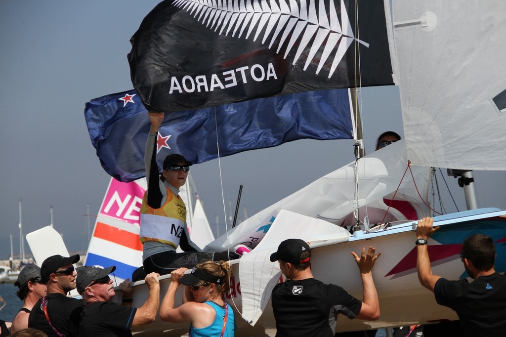  August 10, 2012 - Weymouth, England - Jo Aleh and Olivia Powrie are carried ashore by New Zealand supporters after their Gold Medal win © Richard Gladwell www.photosport.co.nz