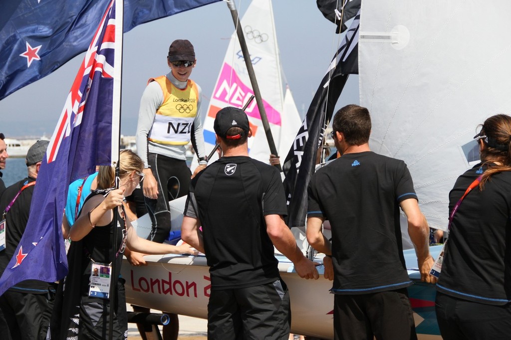 August 10, 2012 - Weymouth, England - Jo Aleh arrives ashore after the Gold Medal win © Richard Gladwell www.photosport.co.nz