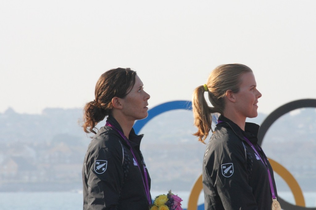  August 10, 2012 - Weymouth, England - Jo Aleh and Olivia Powrie as the NZ Anthem is played at Weymouth photo copyright Richard Gladwell www.photosport.co.nz taken at  and featuring the  class