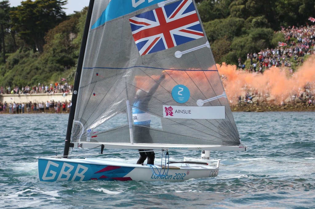  August 5, 2012 - Weymouth, England - Ben Ainslie lets off two smoke flares to acknowledge the crowd after his Gold Medal win photo copyright Richard Gladwell www.photosport.co.nz taken at  and featuring the  class