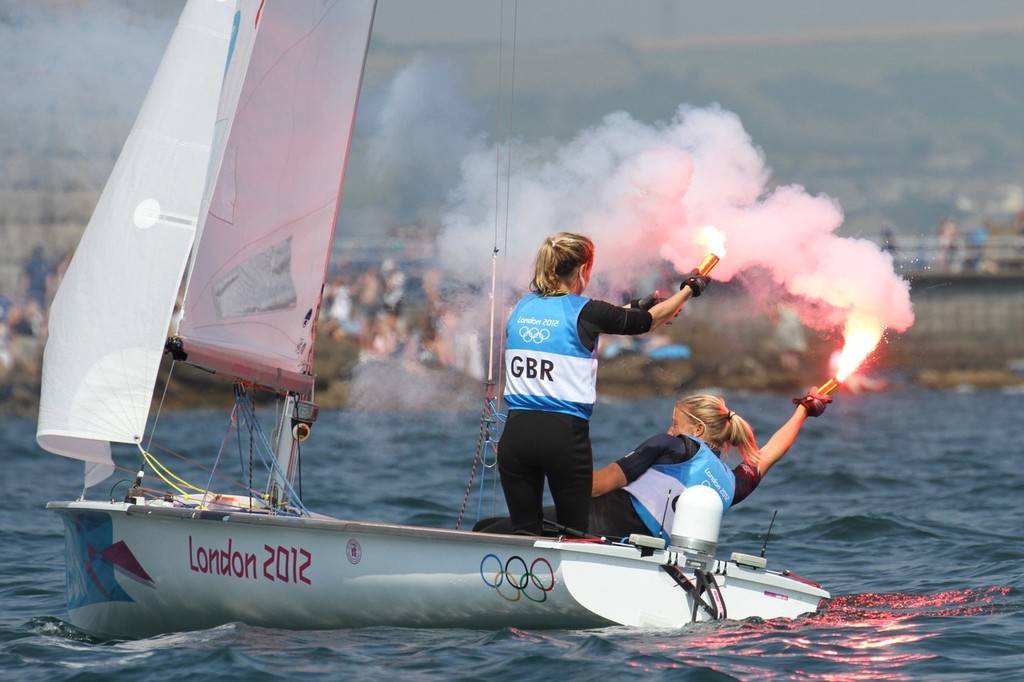 Saskia Clarke and Hannah Mills (GBR) celebrate their Silver medal win with hand-held flares on the Nothe Stadium course © Richard Gladwell www.photosport.co.nz