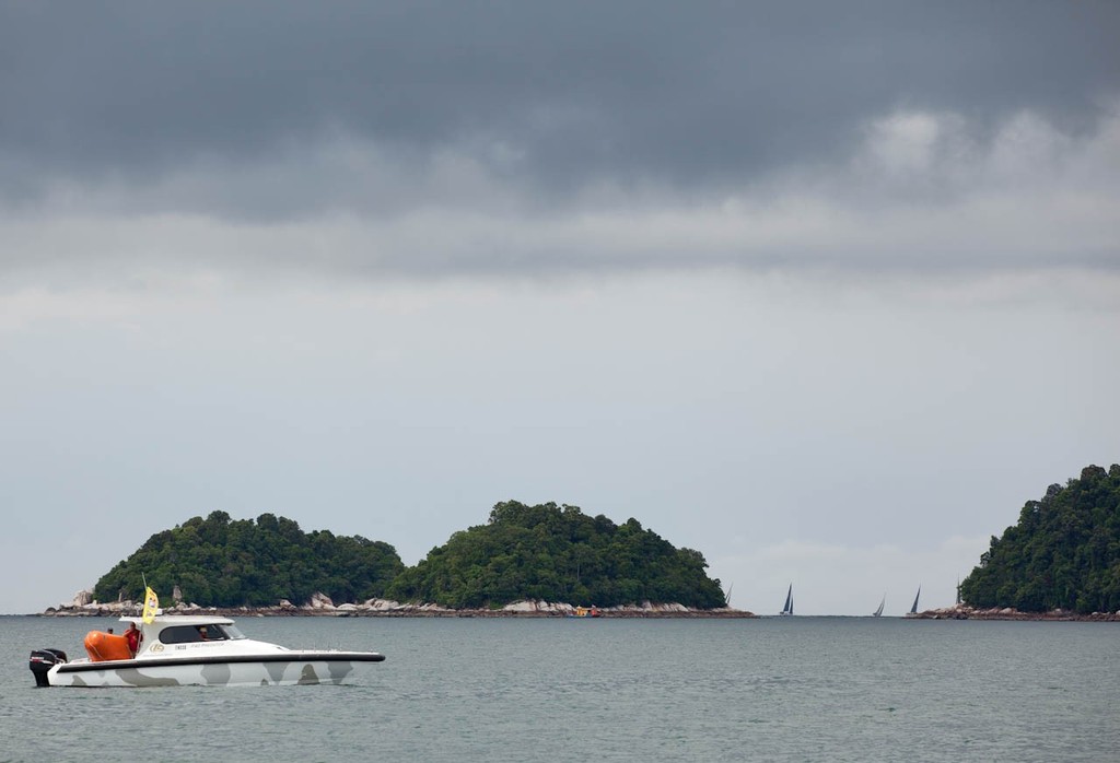 Raja Muda Selangor International Regatta 2012 - Start Boat 2 watches there fleet disappear round the corner of Pangkor Laut © Guy Nowell / RMSIR