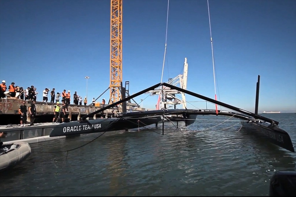 Oracle Team USA is lowered into the water for the first time © SW