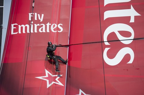 Richard Meacham goes aloft to check the damage to some wingsail ribs and take some photos for the designers, on Day 2.  © Chris Cameron/ETNZ http://www.chriscameron.co.nz