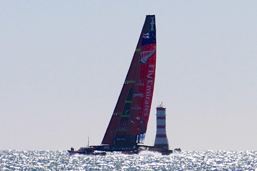 Emirates Team NZ clears Rangitoto Light at the start of yesterday’s testing session in 15-20kts © Richard Gladwell www.photosport.co.nz