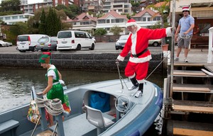 Santa boards for his short nautical journey that is part of his huge worldwide tour... - Rolex Sydney Hobart Yacht Race photo copyright  Alex McKinnon Photography http://www.alexmckinnonphotography.com taken at  and featuring the  class