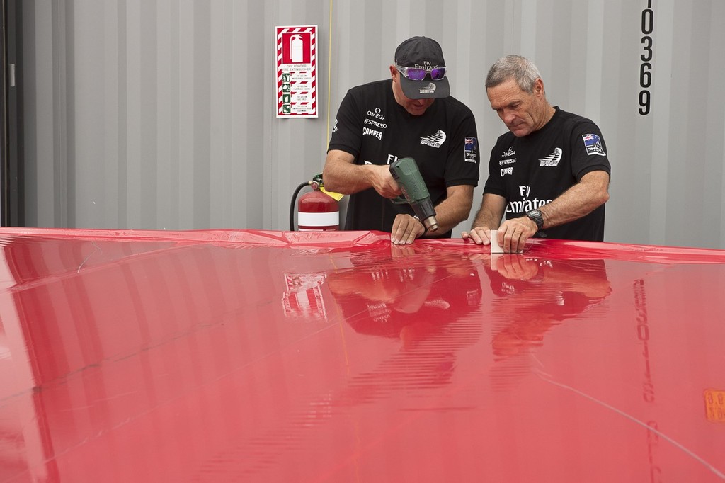 Emirates Team New Zealand, Chris Salthouse and Joe Allen stretch the Mizar skin on to one of the flaps of Wing one. 23/1/2013 photo copyright Chris Cameron/ETNZ http://www.chriscameron.co.nz taken at  and featuring the  class