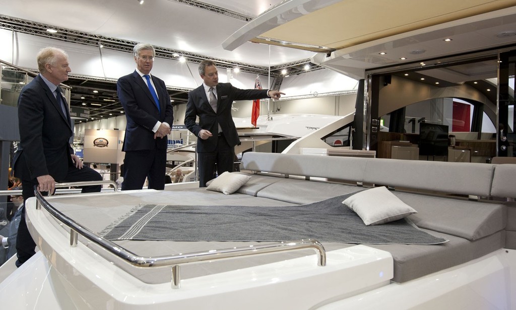 Michael Fallon the Minister for Business  and Howard Pridding the CEO of the British Marine talk to Alastair Schofield, the CEO of Fairline Boats at the Tullett Prebon London Boat Show, ExCeL, London. © onEdition http://www.onEdition.com