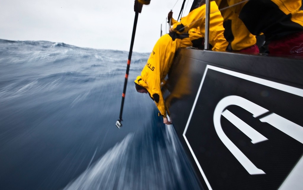 Craig Satterwaite works to tighten some through hull bolts whjile being filmed by Nick Dana on board Abu Dhabi using a Go-Pro on a pole. photo copyright Volvo Ocean Race http://www.volvooceanrace.com taken at  and featuring the  class