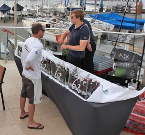 The first sailor to get one of the sponsor’s new 62 Pilsners. - TP52 Southern Cross Cup photo copyright  John Curnow taken at  and featuring the  class