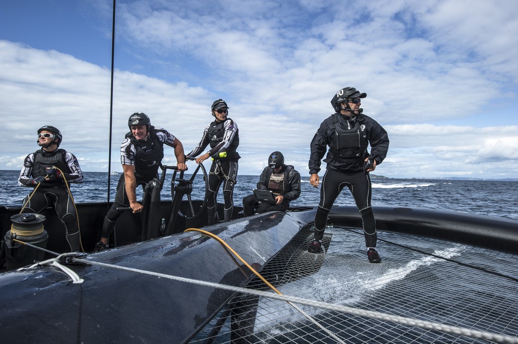 The Members&rsquo; Stand aboard  NZL5 Emirates Team New Zealand, with Glenn Ashby (left) in white sunglasses, skipper Dean barker on the wheel, and tactician, Ray Davies (right)  and Luc du Bois (Performance Analyst) plus a couple of grinders to provide the grunt. photo copyright Chris Cameron/ETNZ http://www.chriscameron.co.nz taken at  and featuring the  class