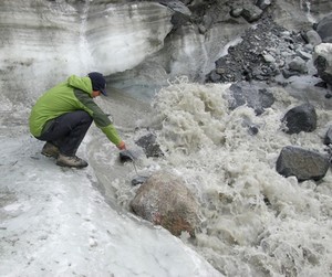 Field assistant Ben Gready measures the electrical conductivity of the ‘N’ glacier outflow. By making this measurement at different times of the season, scientists can compare concentrations of dissolved nutrients in meltwater passing through the subglacial environment. Early in the melt season, the network of tunnels and chasms under the glacier is less efficient at draining meltwater, extending the meltwater's contact with sediments and bedrock, thus picking up more dissolved nutrients. photo copyright Matt Charette, WHOI http://www.whoi.edu/ taken at  and featuring the  class