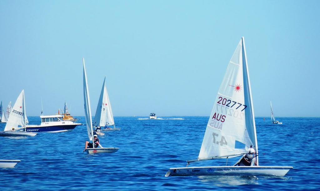 Concentration required – Laser 4.7 sailors negotiate a light patch. photo copyright Annette Walker taken at  and featuring the  class