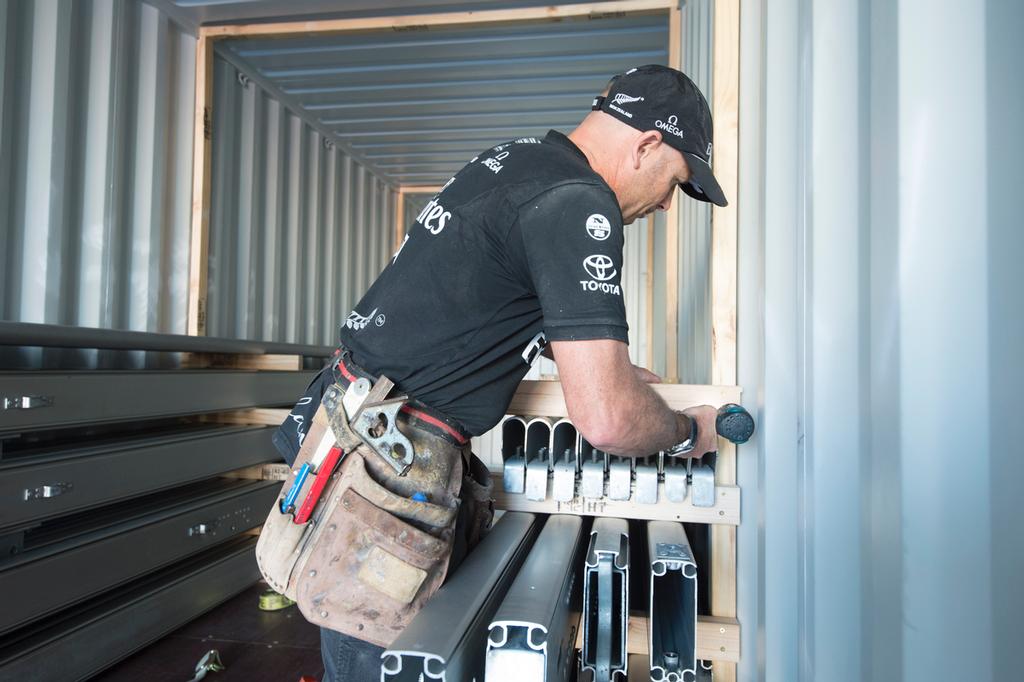 Emirates Team New Zealand, James Dagg works on loading tent structural sections  into containers for shipping to San Francisco. 8/4/2013 © Chris Cameron/ETNZ http://www.chriscameron.co.nz