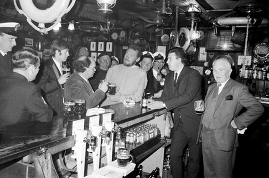 Circa 22nd April 1969: Robin Knox-Johnston regailing friends with stories of his solo circumnavigation, in the bar of the Royal Cornwall Yacht Club after becoming the first man to sail solo non-stop around the globe. Knox-Johnston was the sole finisher in the Sunday Times Golden Globe solo round the world Falmouth, England on 14th June 1968 © Bill Rowntree - PPL http://www.pplmedia.com