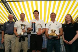 The crew from 5 West, the 2013 winners of the Gold Roman Bowl. 

Jonathan Taylor, Alex Mills, Robert Greenhalgh are flanked by left, Sir Robin Knox-Johnston and on the right, Corrie McQueen from J.P. Morgan Asset Management - 2013 Round the Island Race photo copyright Patrick Eden taken at  and featuring the  class