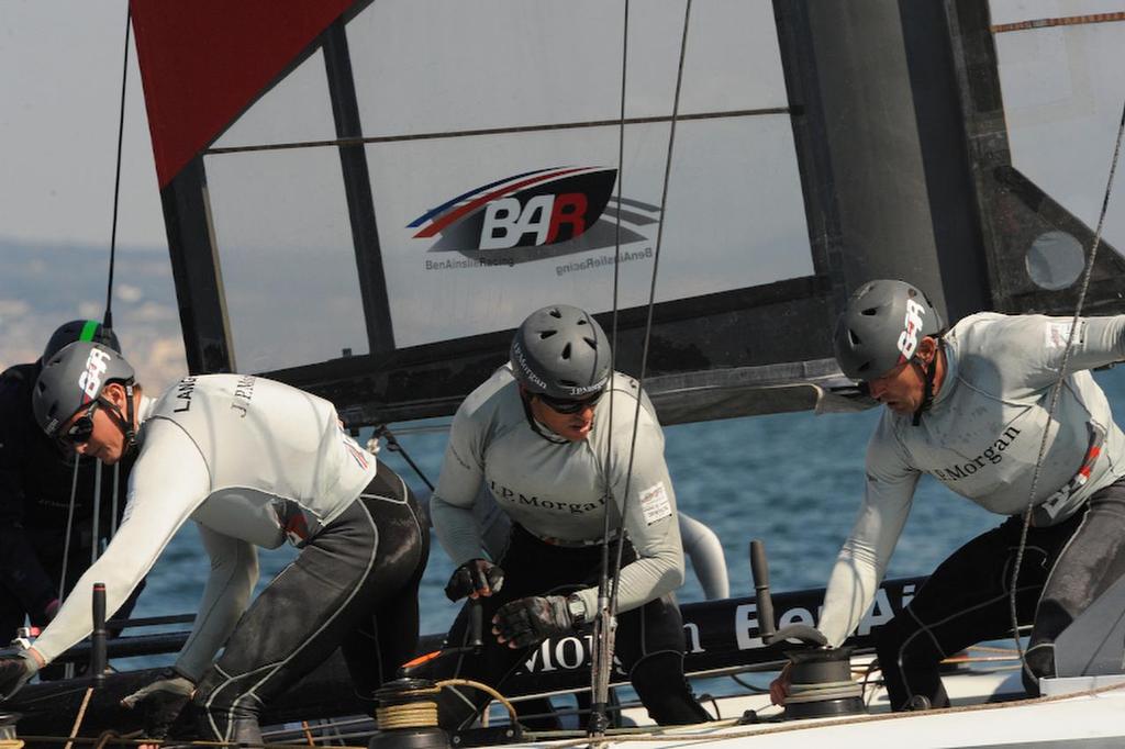 Kyle Langford, wing trim, Matt Mitchell, runner, and Simon Daubney, trimmer, bring J.P.Morgan Bar  through the windward gate and on to placing first in the second race at the ACWS in Naples Italy on April 18, 2013. ©  SW