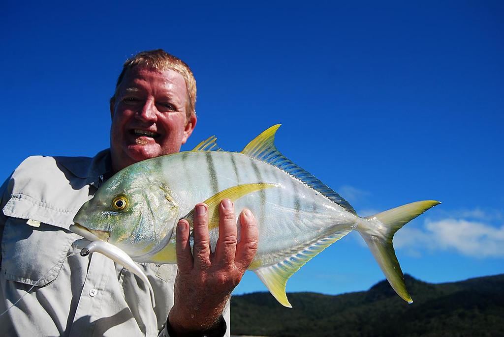 Graham Brake with a little golden trevally that took a Zman StreakZ around Brampton Island. © Lee Brake