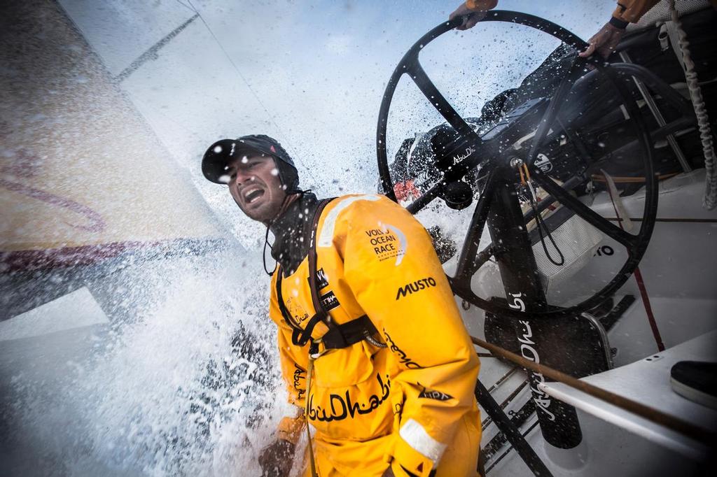 March 19, 2015. Leg 5 to Itajai onboard Abu Dhabi Ocean Racing. Day 01. Louis Sinclair turns away from the next wave of 19 degree water, pausing before jumping back on the pedestal. © Matt Knighton/Abu Dhabi Ocean Racing