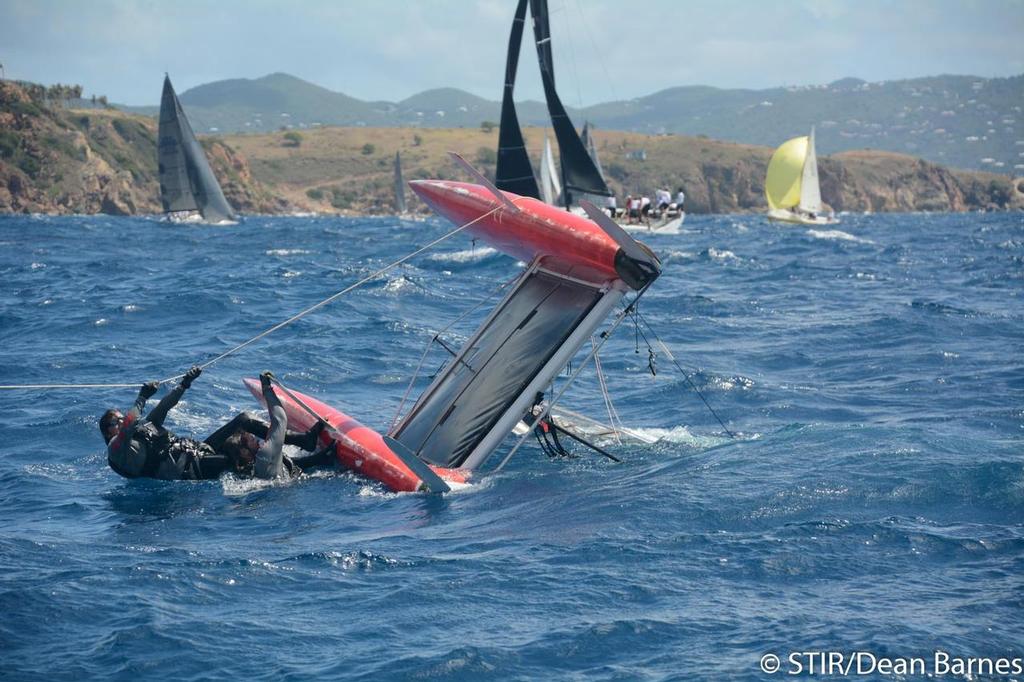 A beach cat capsizes during the first day of racing in the St. Thomas International Regatta. © Dean Barnes