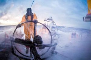 Onboard Abu Dhabi Ocean Racing - Phil Harmer,Louis Sinclair,and Luke Parko Parkinson under the shower as the clouds part behind them at sunset - Volvo Ocean Race 2015 photo copyright Matt Knighton/Abu Dhabi Ocean Racing taken at  and featuring the  class