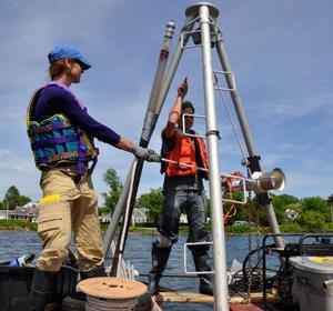 Working from a pontoon platform, the research team collected a sediment core from Salt Pond in Falmouth, Mass. An aluminum tube was vibrated through the metal tripod into the muddy sediment at the bottom of the pond and then extracted with a hoist. The core provides evidence of intense storm events going back approximately 2000 years - Prehistoric-hurricanes photo copyright WHOI Archives taken at  and featuring the  class