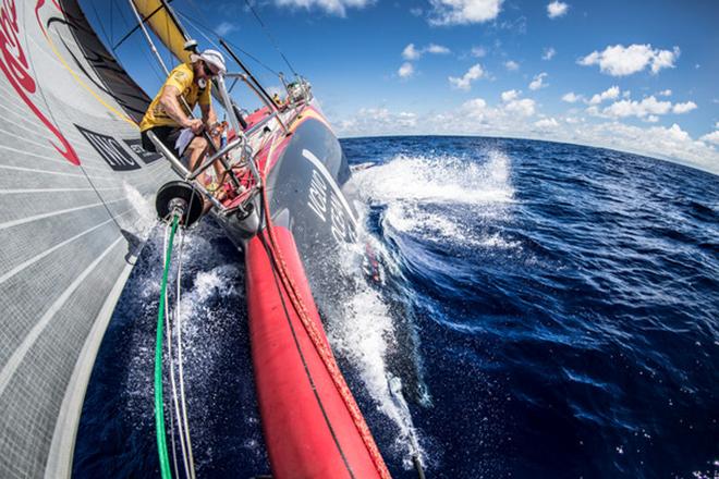 April,2015. Leg 6 Newport onboard Abu Dhabi Ocean Racing. Day 4. Justin Slattery tries to stay dry while performing maintenance on the forestay as Azzam plows east into the Atlantic Ocean.  © Matt Knighton/Abu Dhabi Ocean Racing