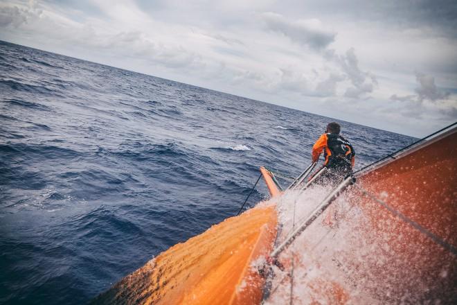 Leg 6 to Newport onboard Team Alvimedica. Day 03. Nick Dana scoops the ocean on the bow while checking for chafing at the jib tack. Conditions remain largely the same for the third consecutive day of upwind sailing east and away from a chasing cold front. - Volvo Ocean Race 2015 ©  Amory Ross / Team Alvimedica