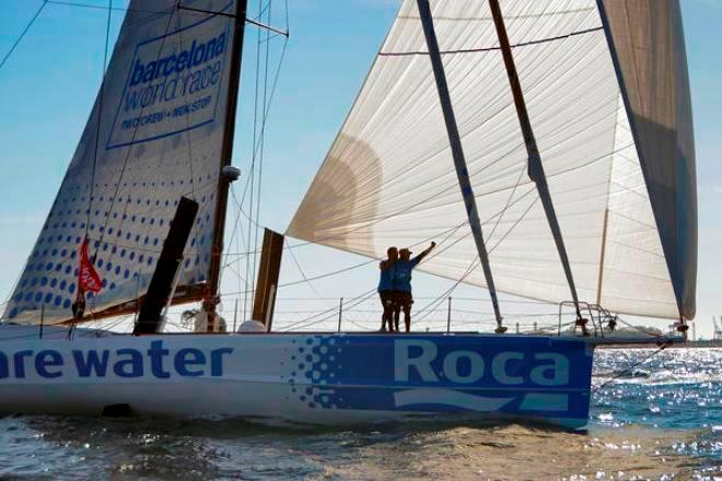 We Are Water - skippers Bruno and Willy Garcia crossing the finish line in fifth place - Barcelona World Race 2015 ©  Mireia Perello