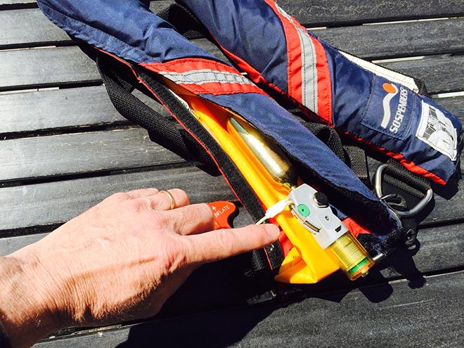 Checking the inflation mechanism is a key part of preparing your inflatable life jacket for another season. © D. Scott Croft