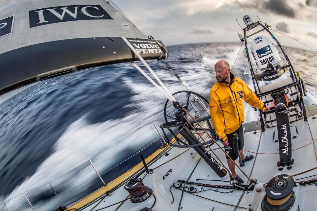 April 21, 2015. Leg 6 to Newport onboard Abu Dhabi Ocean Racing. Day 2.  Ian Walker pensively looks towards MAPFRE on the horizon while grinding the main sail in the Atlantic Ocean. © Matt Knighton/Abu Dhabi Ocean Racing