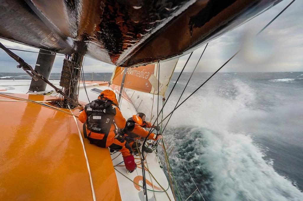 April 1, 2015. Leg 5 to Itajai onboard Team Alvimedica. Day 15. Conditions worsen as the fleet outuns a nasty system of low pressure moving east off the coast of South America, with upwind sailing in 35-40 knots of wind creating uncomfortable sailing. Nick Dana and Dave Swete work on the jib leads in windy upwind conditions. ©  Amory Ross / Team Alvimedica
