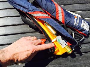 Checking the inflation mechanism is a key part of preparing your inflatable life jacket for another season. photo copyright D. Scott Croft taken at  and featuring the  class