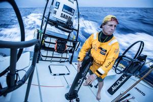 Leg 6 Newport onboard Abu Dhabi Ocean Racing. Day 14. Luke ``Parko`` Parkinson at dusk on the aft pedestal halfway between clothing choices as the Caribbean fades in the distance and the cold water of the North Atlantic loom closer. photo copyright Matt Knighton/Abu Dhabi Ocean Racing taken at  and featuring the  class