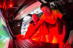 Simon 'SiFi' Fisher and skipper Ian Walker look at the latest AIS readings  during Leg 7 of the Volvo Ocean Race from USA to Portugal - Volvo Ocean Race 2015 photo copyright Matt Knighton/Abu Dhabi Ocean Racing taken at  and featuring the  class