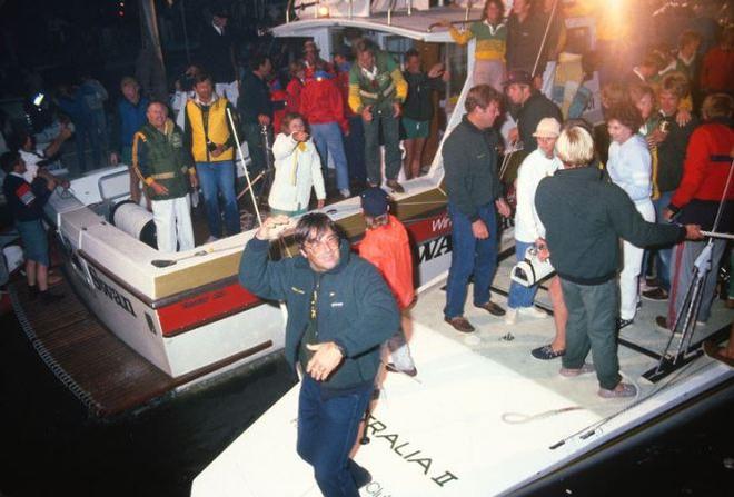 Ben Lexcen dancing on the stern of AUSTRALIA II Dennis Conner with NYYC straw hat in background - America’s Cup 1983 © Daniel Forster / go4image.com http://www.go4image.com