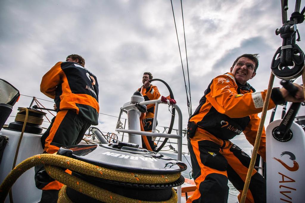 June 18, 2015. Leg 9 to Gothenburg onboard Team Alvimedica. Day 2. A windy night of sailing and a decision to stay south of the TSS traffic separation scheme sees another day of sailing along the French coast on the north towards The Hague. Charlie Enright on the wheel through a tack while Dave Swete (L) and Will Oxley (R) go about their grinding duties. ©  Amory Ross / Team Alvimedica