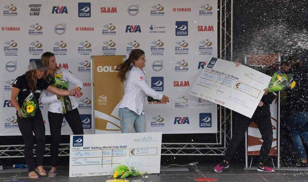 Alexandra Maloney and Molly Meech, NZL, Martine Soffiatti Grael and Kahena Kunze, BRA and Tamara Echegoyen and Berta Betanzos Moro, ESP, Women's Skiff (49erFX) prize giving on day five of the ISAF Sailing World Cup Weymouth & Portland. © onEdition http://www.onEdition.com