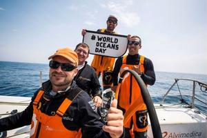 Onboard Team Alvimedica – Team Alvimedica celebrates #WORLDOCEANSDAY from the North Atlantic after a morning of playing with dolphins. (L to R - Ryan Houston, Will Oxley, Charlie Enright, Mark Towill). - Leg 8 to Lorient – Volvo Ocean Race 2015 photo copyright  Amory Ross / Team Alvimedica taken at  and featuring the  class
