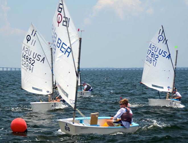 The Lake Ontario Opti Team LOOT 1 (Team 16) continued their winning ways on Monday on Circle B. LOOT 1 made the cut into the Gold round-Robin on Tuesday to determine the champion. Also making the top four cut were CERT, Lakewood Red and Lakewood Blue. Loot has members from Canada, USA and Bermuda. Sail #BER1099 is Bermudian Adam Larson. © Talbot Wilson