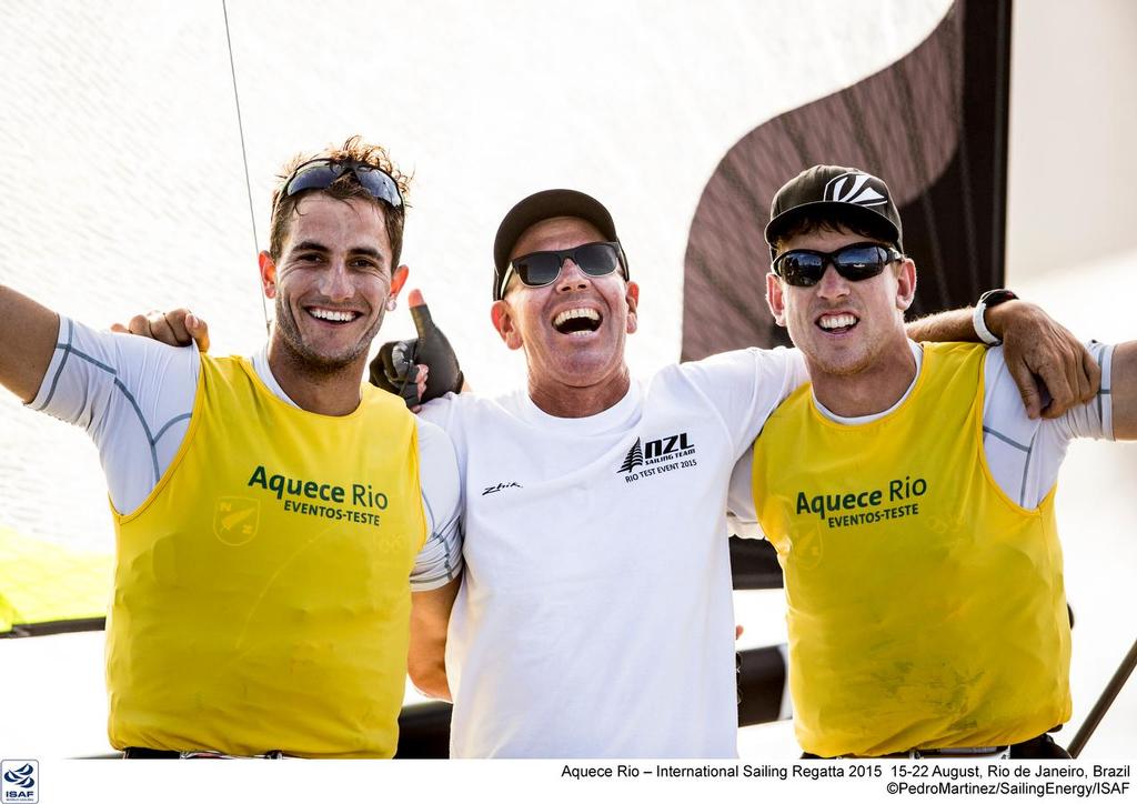 Blair Tuke, coach Dan Willcox and Peter Burling after their Gold medal win at the Pre-Olympics © Sailing Energy/ISAF