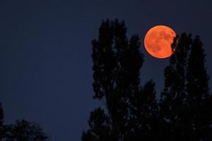 A 'supermoon' is seen from the central French city of Luynes, in September 2014 photo copyright AFP Photo / Guillaume Souvant taken at  and featuring the  class