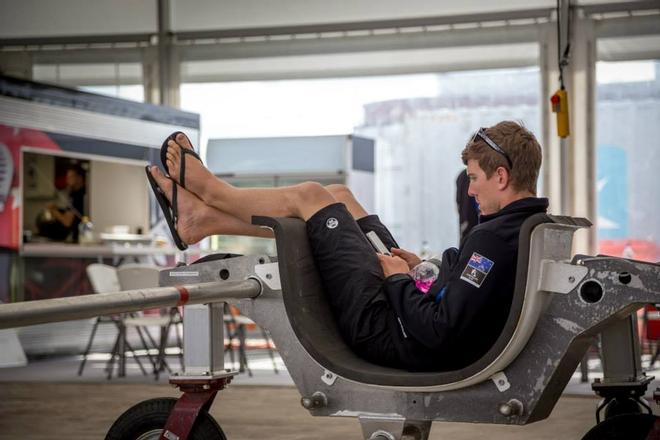 Helmsman Peter Burling relaxes before racing in an AC45 